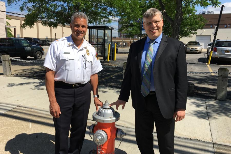 Cleveland Fire Chief Angelo Calvillo and Commissioner of Water Alex Margevicius stand next to a fire hydrant on a city street