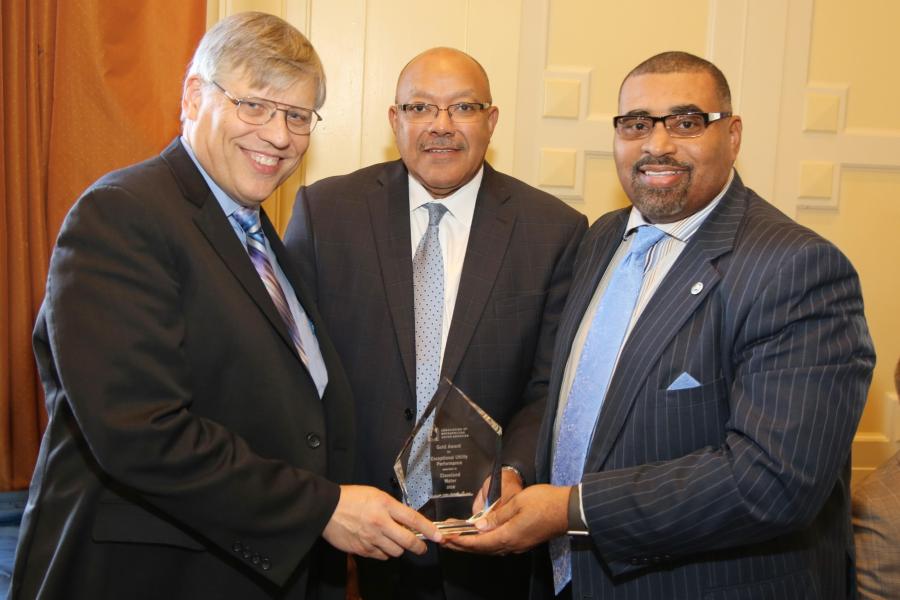 Commissioner of Water Alex Margevicius and Director of Public Utilities Robert Davis hold an award from the Association of Metropolitan Water Agencies