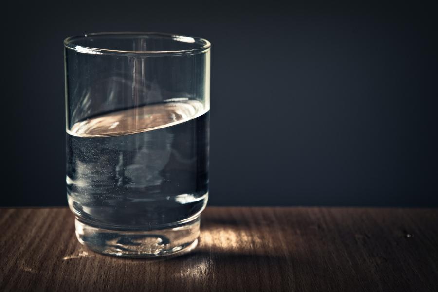 A glass of water sitting on a table