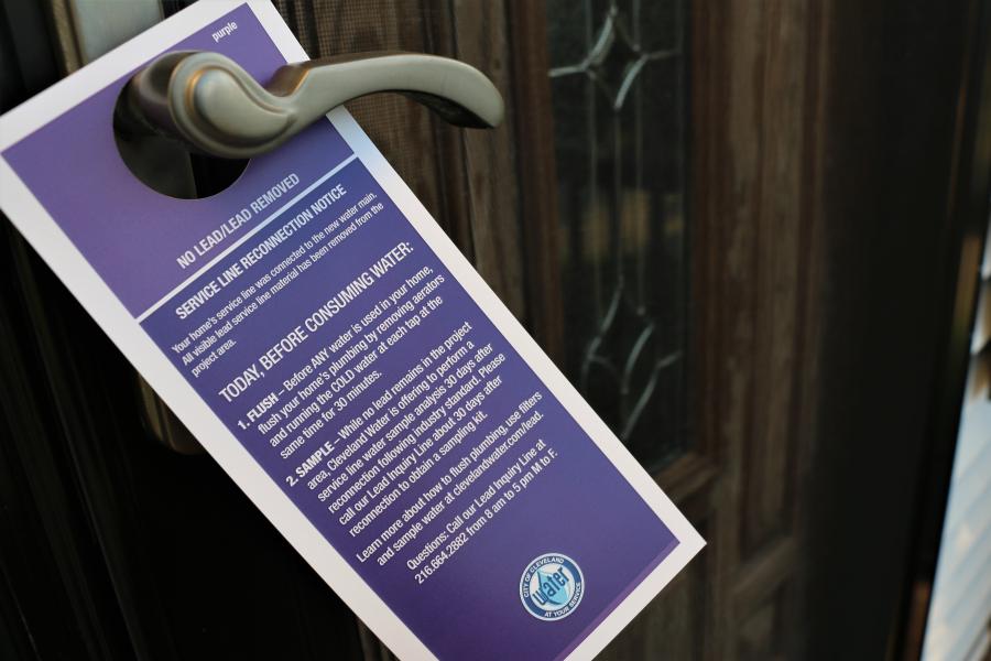 A Cleveland Water notice hanging on a door handle