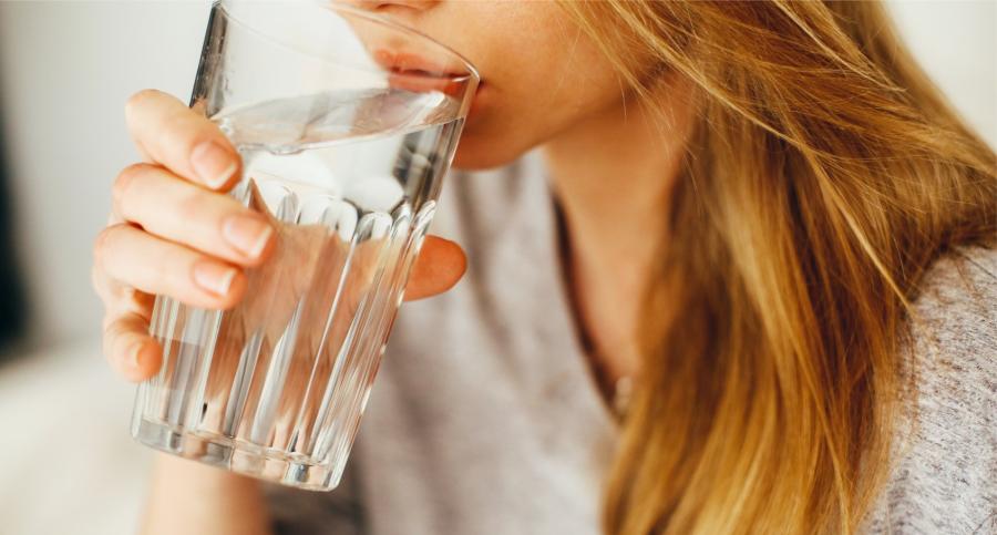Close up of a woman drinking water from a glass